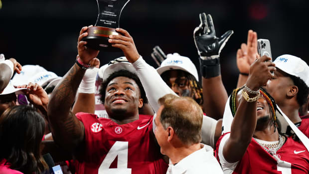 Dec 2, 2023; Atlanta, GA, USA; Alabama Crimson Tide quarterback Jalen Milroe (4) celebrates with the most valuable player trophy after the Alabama Crimson Tide defeated the Georgia Bulldogs in the SEC Championship at Mercedes-Benz Stadium.